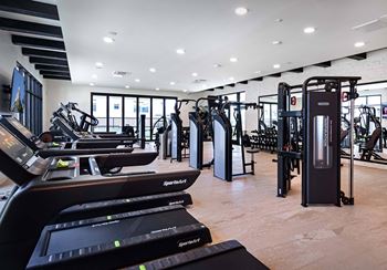 a gym with treadmills and other exercise equipment